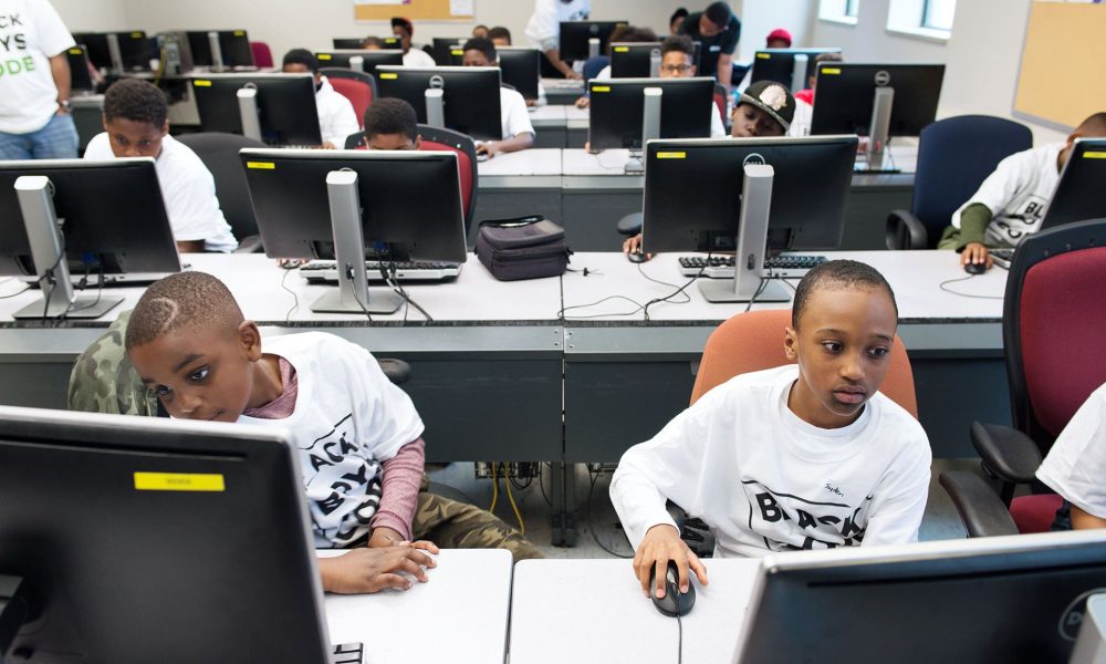 Two students working on a computer at a Black Boys Code workshop.