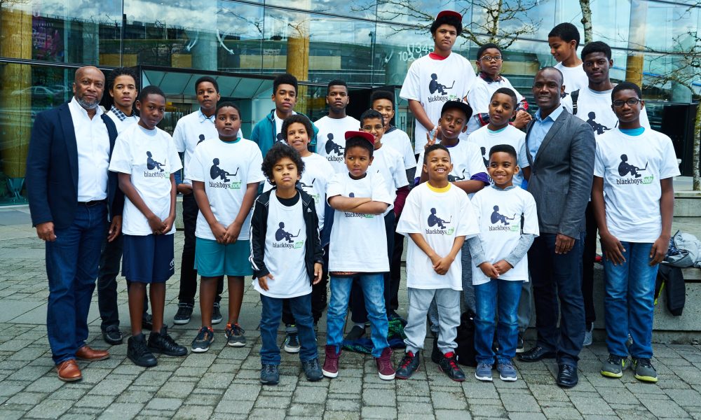 Bryan Johnson, left, a coding workshop crew and Germain Tanoh, who talked to the boys about his path to becoming a mathematician in Canada.
